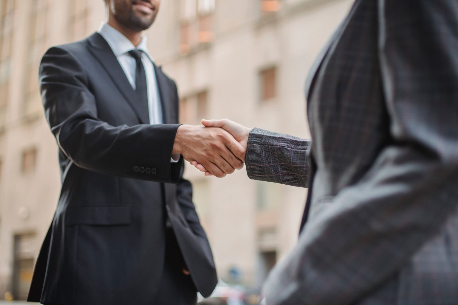 Procurement executives shaking hands after a negotiation